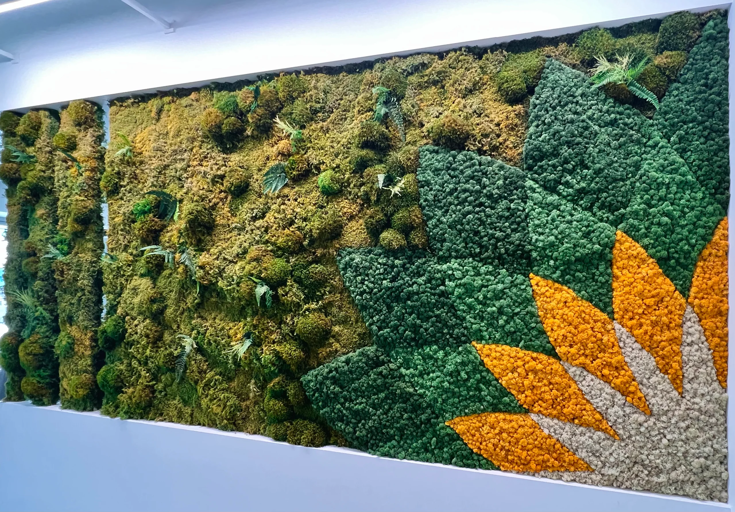 A moss wall with an orange sunburst