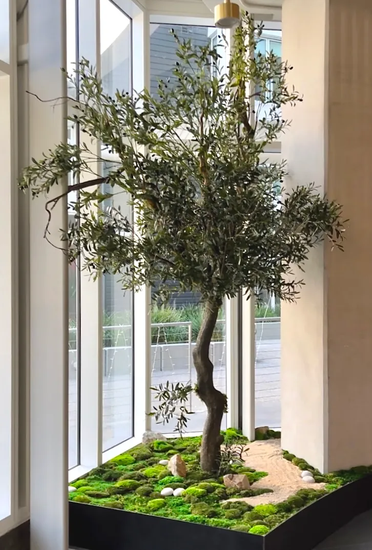 A faux olive tree in a planter