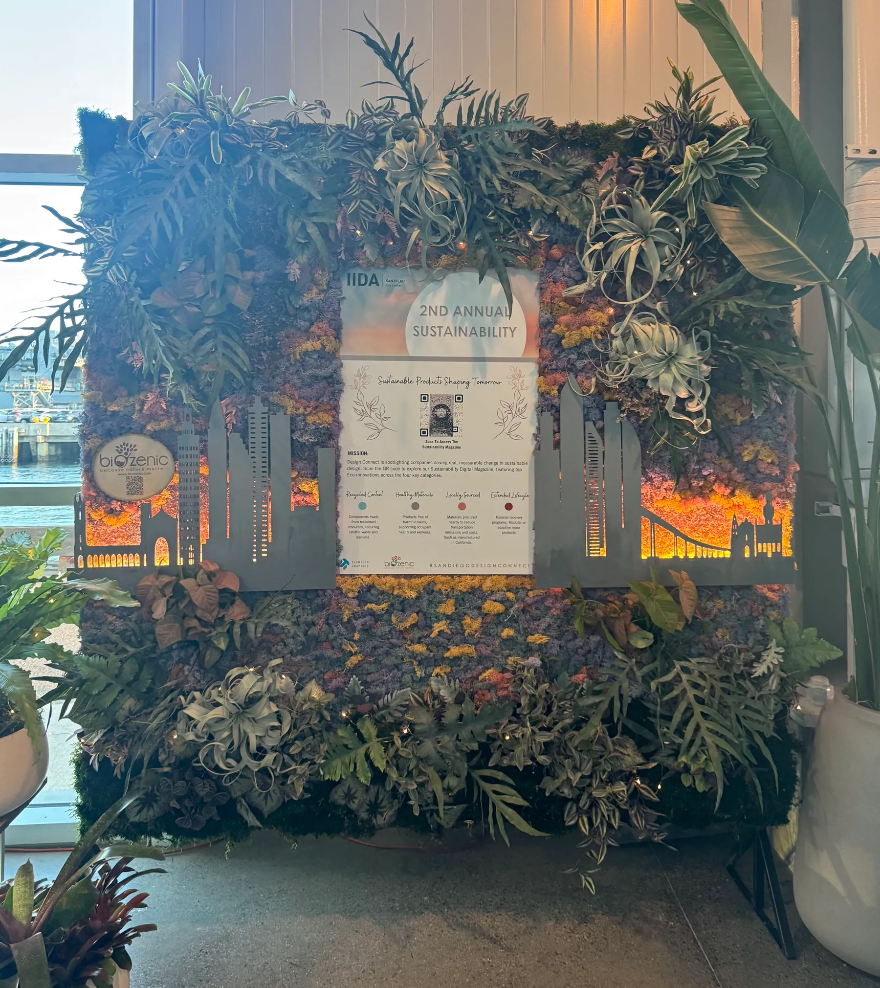 A moss and air plant wall with a city skyline cutout at IIDA Design Connect 2026
